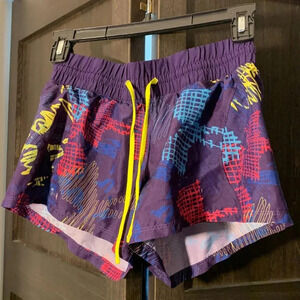 Under Armour heat gear shorts (Purple background, pink, yellow & blue print).